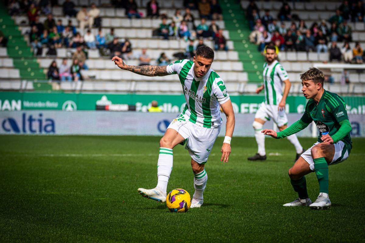 Carlos Isaac se lleva el balón ante un rival racinguista, este sábado, en A Malata.