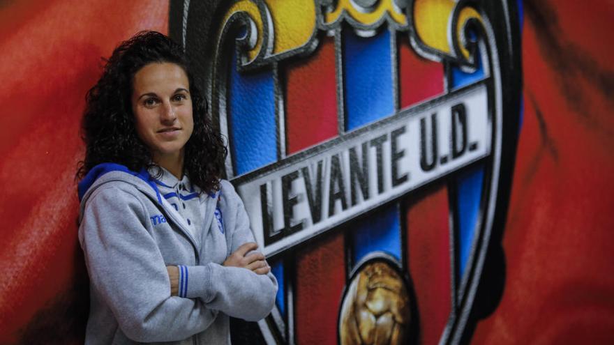 María de Alharilla posa junto al escudo del Levante UD, en el Ciutat de València.