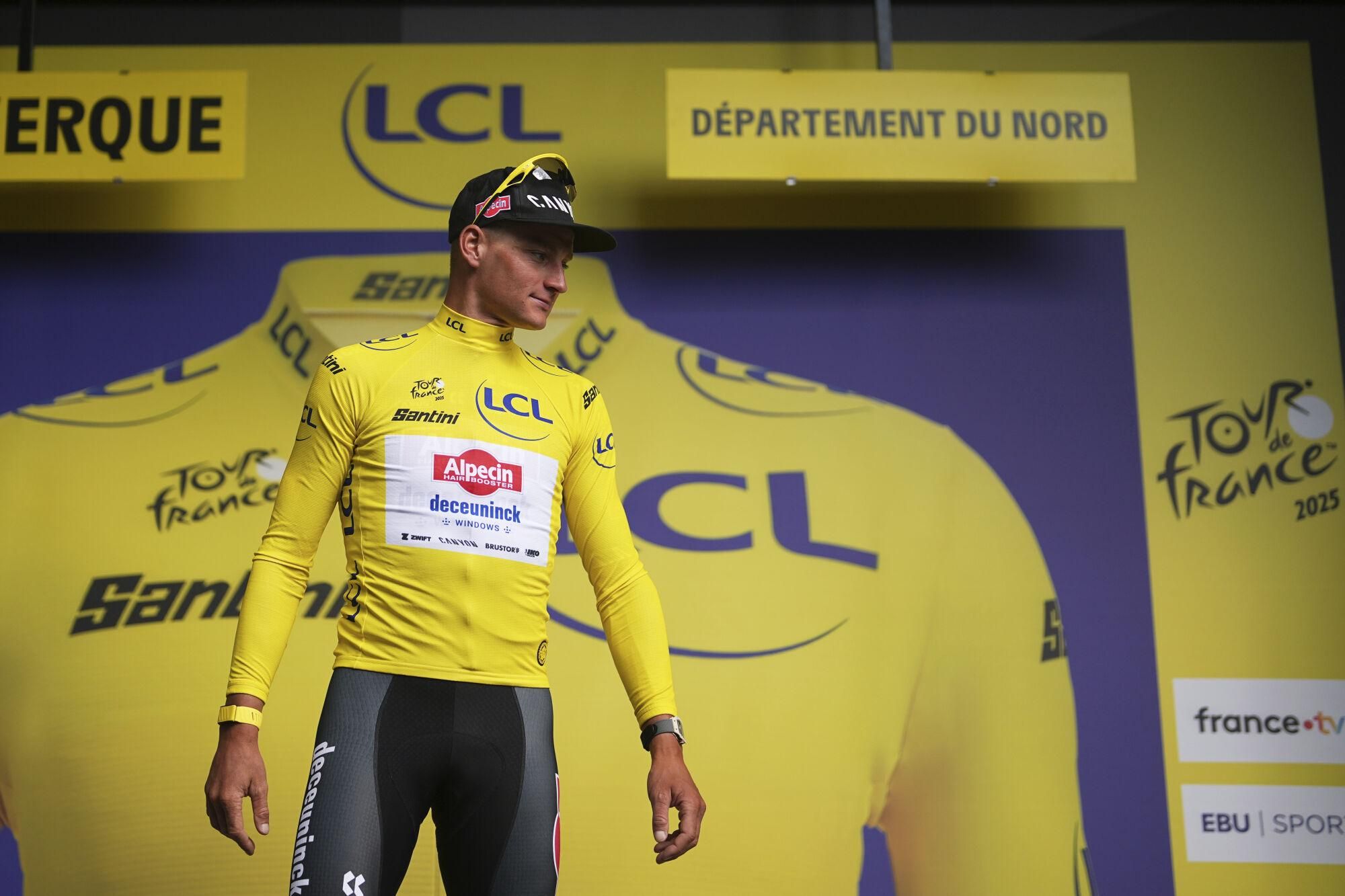 Netherlands' Mathieu van der Poel wearing the overall leader's yellow jersey arrives on the podium after the third stage of the Tour de France cycling race over 178.3 kilometers (110.8 miles) with start in Valenciennes and finish in Dunkerque, France, Monday, July 7, 2025. (AP Photo/Thibault Camus)