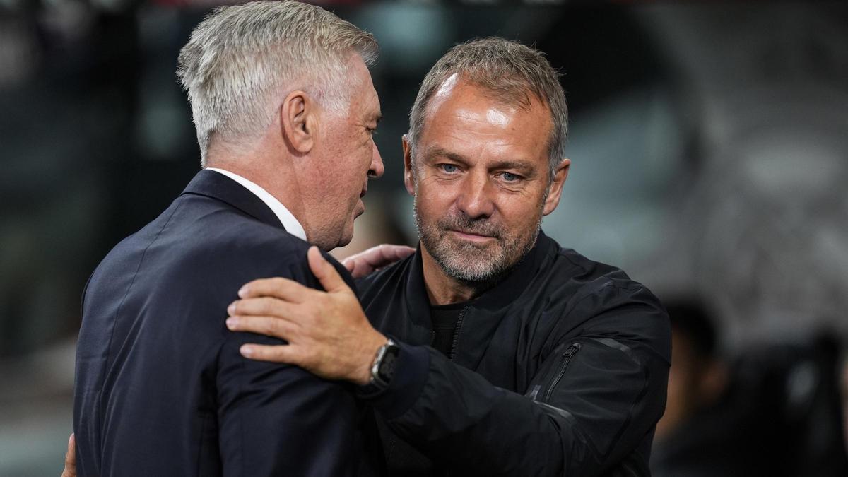 Ancelotti and Flick greet each other before starting the final of the Copa del Rey in Seville.