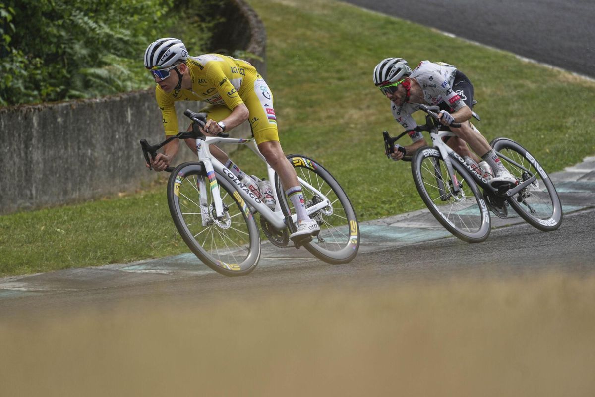Slovenias Tadej Pogacar, wearing the overall leaders yellow jersey, and teammate Britains Adam Yates ride on the Charade Circuit during the tenth stage of the Tour de France cycling race over 165.3 kilometers (102.7 miles) with start in Ennezat and finish in Le Mont-Dore Puy de Sancy, France, Monday, July 14, 2025. (AP Photo/Thibault Camus). EDITORIAL USE ONLY / ONLY ITALY AND SPAIN