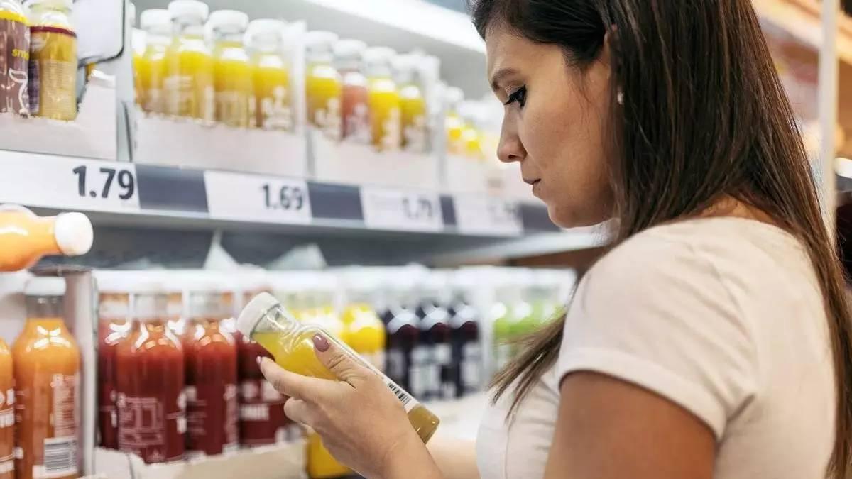 Una dona mira complements alimentaris bevibles