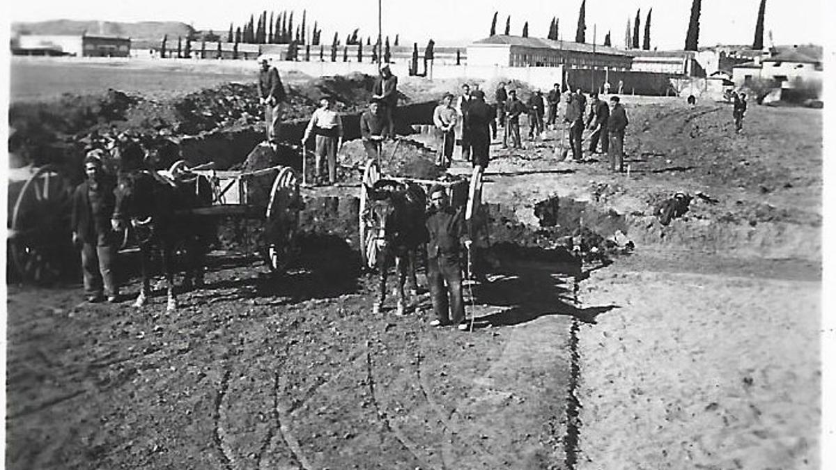 Paletes i voluntaris construint la plataforma de les pistes