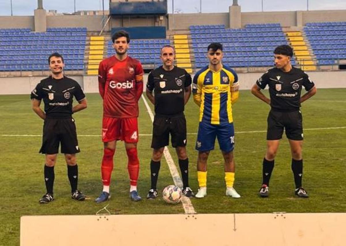 Fotografia inicial amb els capitans i l'equip arbitral de l'anada, que va guanyar el Palamós per 2-1.