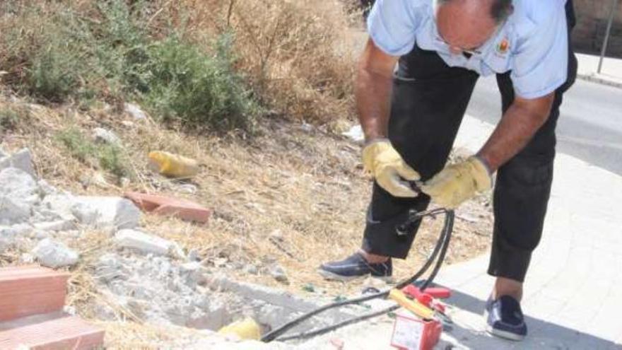 Un operario municipal repone el cable robado en la zona de La Melva para después sellar las arquetas.