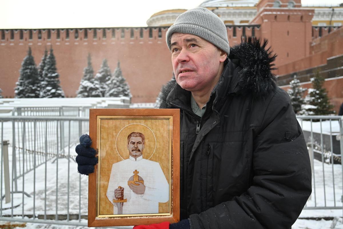 Un visitante de la necrópolis del Kremlin que lleva un icono con la imagen del dirigente soviético Iósif Stalin en Moscú.