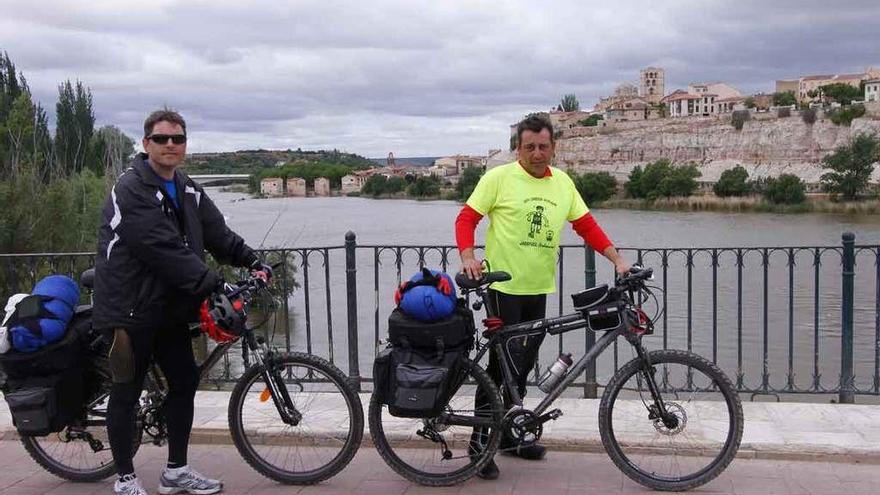 Dos peregrinos llegan a Zamora por el Puente de Piedra siguiendo la Ruta Jacobea.