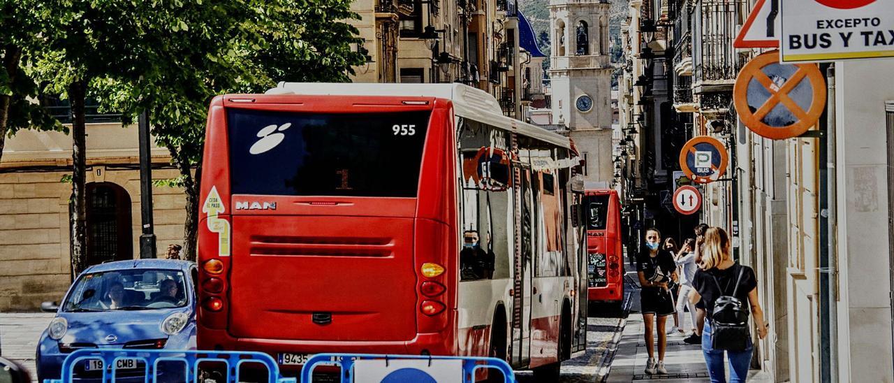 Dos autobuses bajando por la calle San Nicolás, en el centro histórico de Alcoy, un recorrido que solo ellos pueden llevar a cabo tras la peatonalización. | JUANI RUZ