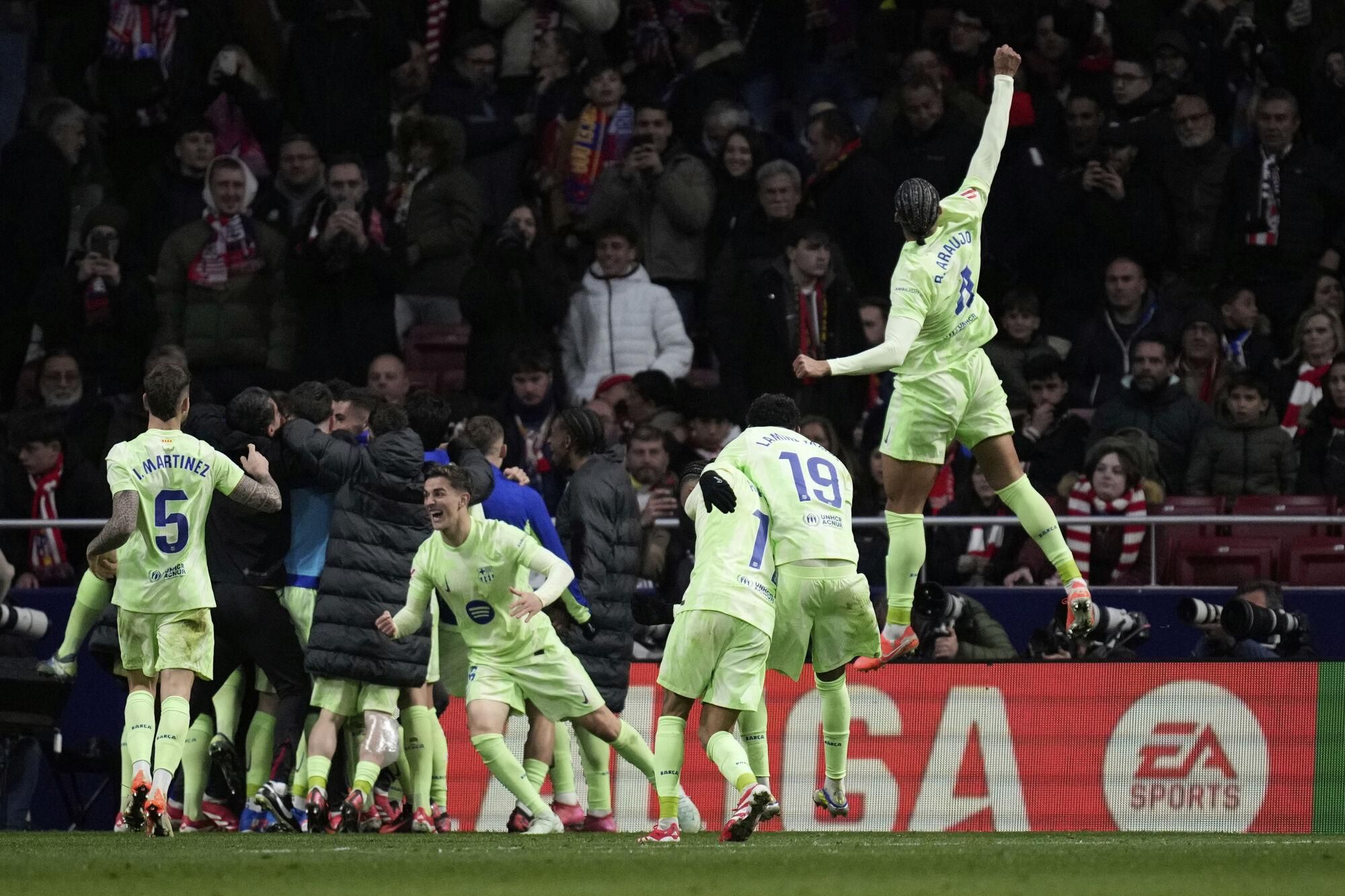 Barcelona's players celebrate their side's 4th goal scored by Ferran Torres during a La Liga soccer match between Atletico Madrid and FC Barcelona at the Metropolitano stadium in Madrid, Sunday, March 16, 2025. (AP Photo/Bernat Armangue)