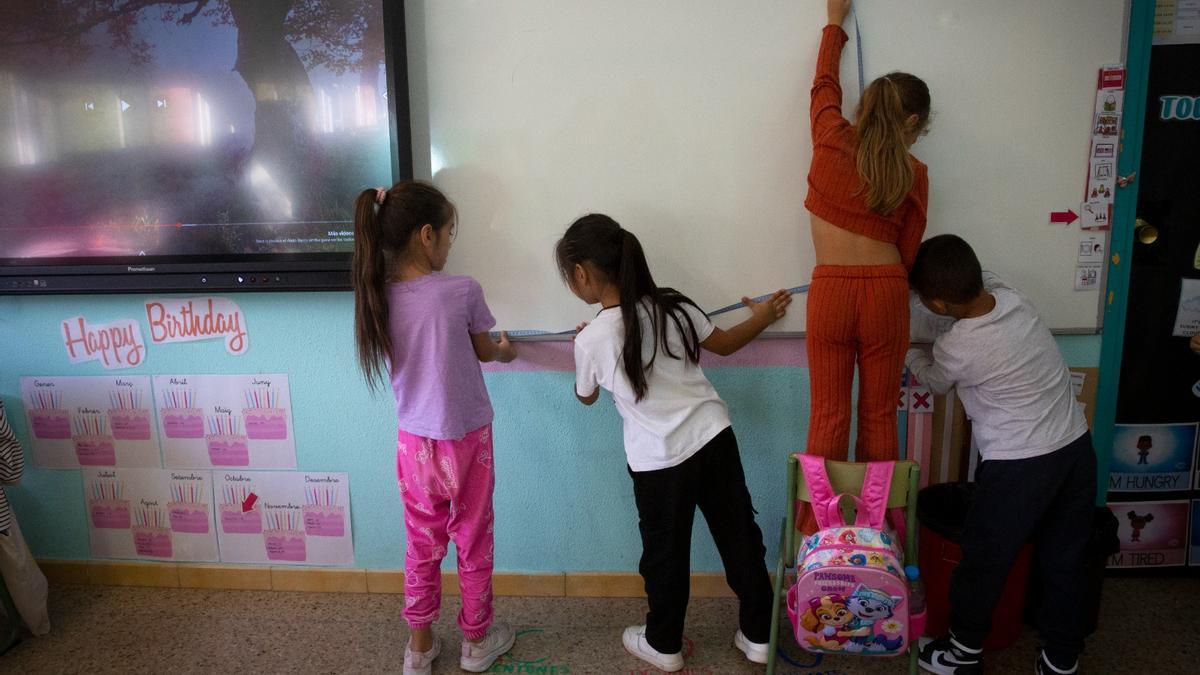 Alumnado de una escuela catalana haciendo tomando medidas en su clase.