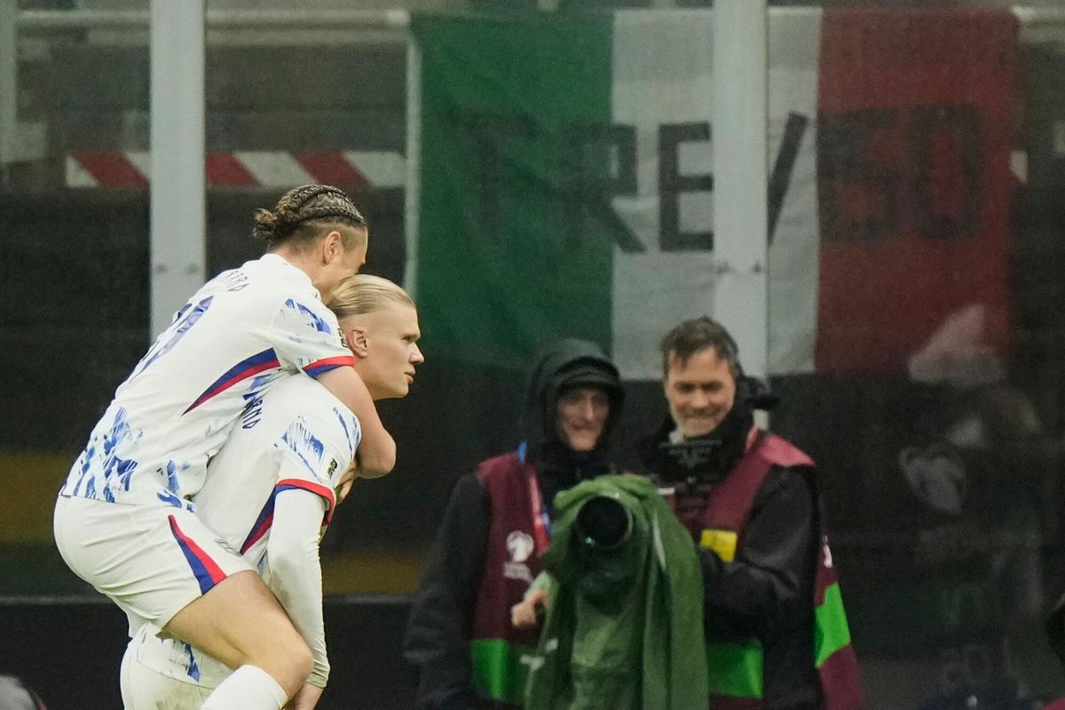 Norway's Erling Haaland, right, celebrates with Thelo Aasgaard after scoring his side's second goal during the 2026 World Cup Group I qualifier soccer match between Italy and Norway in Milan, Italy, Sunday, Nov. 16, 2025. (AP Photo/Luca Bruno)