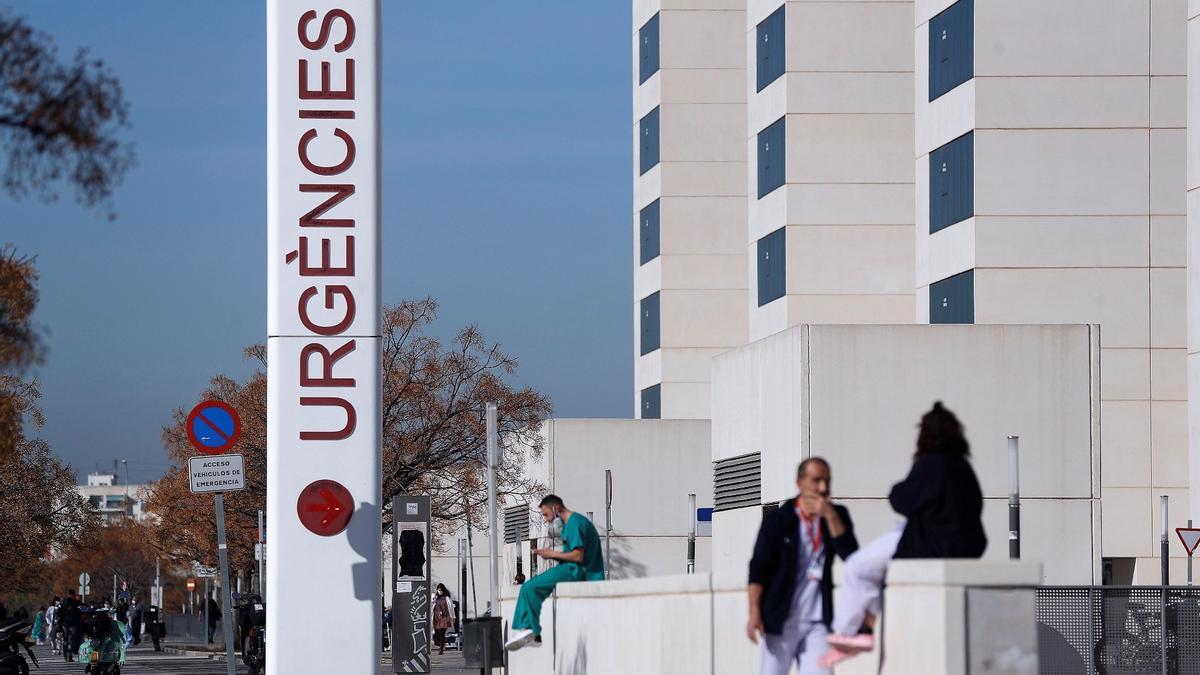 Personal sanitario del Hospital La Fe de València descansa a las puertas de urgencias del centro hospitalario, este martes