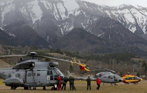 Rescue helicopters from the French Securite Civile and the Air Force are seen in front of the French Alps during a rescue operation near the crash site of an Airbus A320