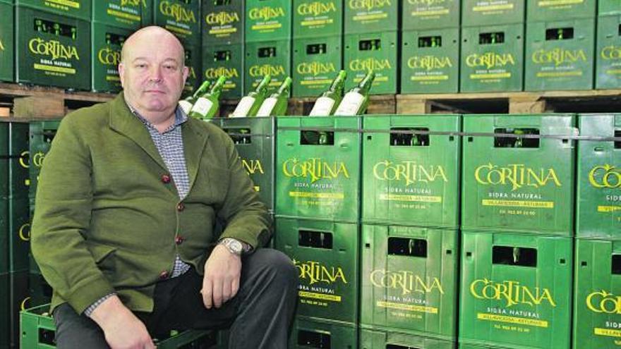 Eloy Cortina, junto a varias cajas de sidra, en su llagar de Amandi, en Villaviciosa.