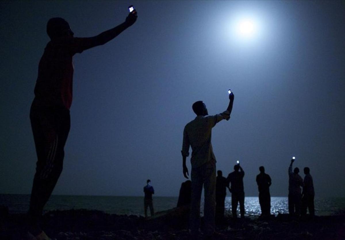 El fotògraf nord-americà John Stanmayer ha guanyat aquest divendres el World Press Photo, la màxima distinció del fotoperiodisme mundial amb la instantània ’Senyal’, en què un grup d’immigrants africans busca cobertura per als seus telèfons mòbils a la frontera de Djibouti, país de la Banya d’Àfrica.