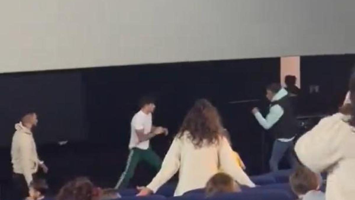 Dos hombres se pelean en una sala de cine