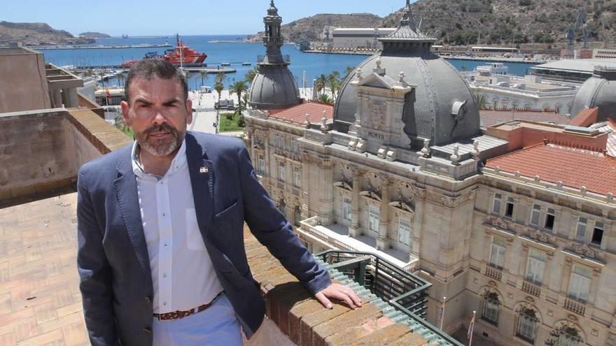 José López en la azotea de un edificio de la plaza del Ayuntamiento con el puerto y el Palacio Consistorial de fondo.