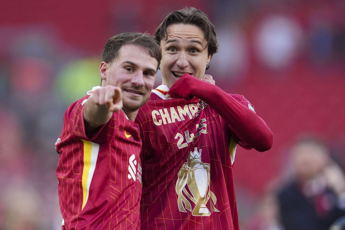 Liverpool's Alexis Mac Allister, left, and Liverpool's Federico Chiesa celebrate after winning the English Premier League soccer match between Liverpool and Tottenham Hotspur and clinching the Premier League title at Anfield in Liverpool, England, Sunday, April 27, 2025. (AP Photo/Jon Super)