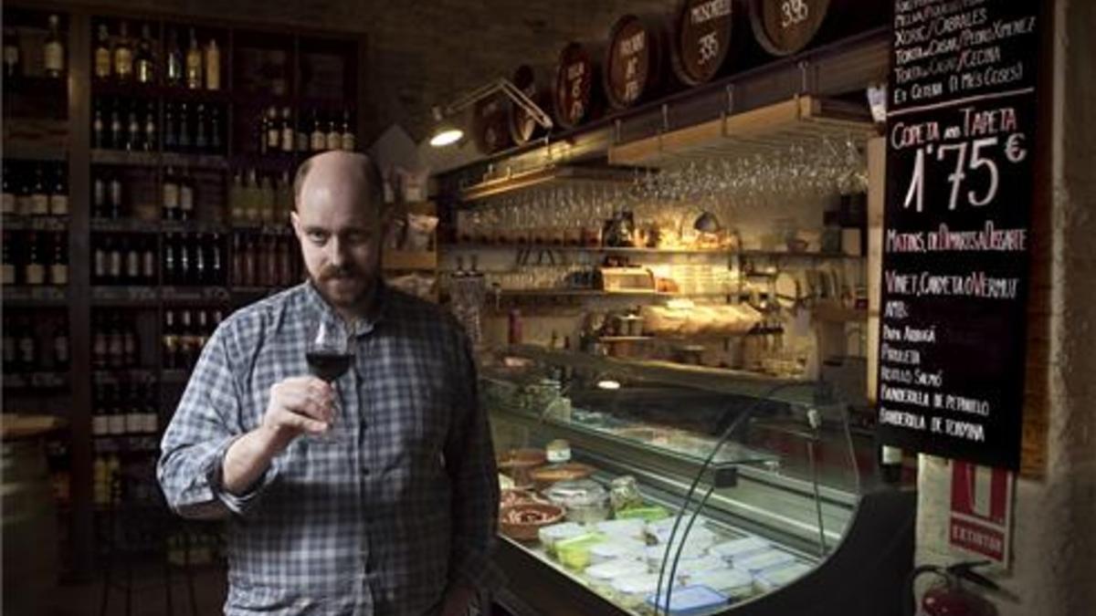 Eduard Burrull, con una copa ante una de las vitrinas de la bodega. Foto: Joan Cortadellas