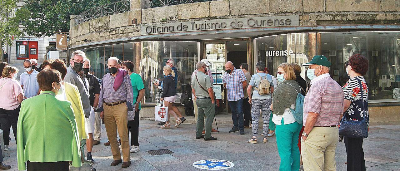Visitantes frente a la oficina municipal de turismo de Ourense, ayer. |   // IÑAKI OSORIO