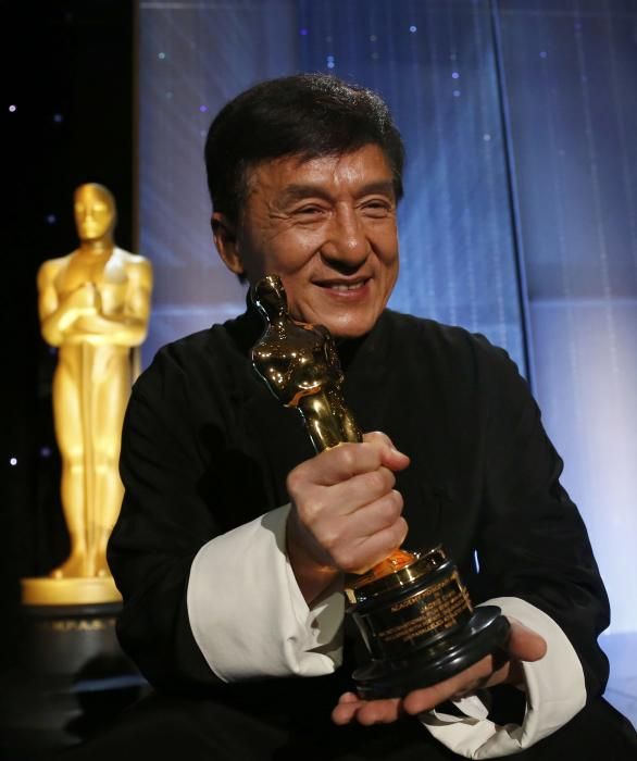 Actor Jackie Chan poses with his Honorary Award ...