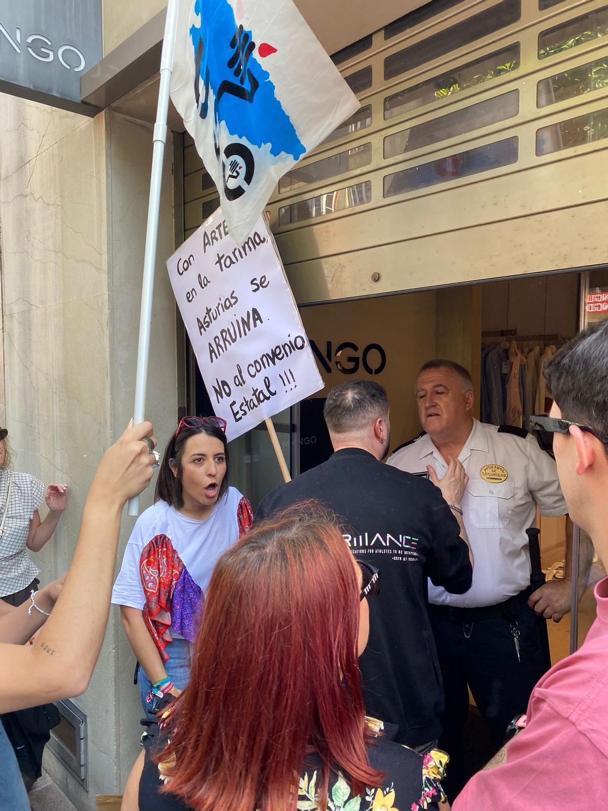 Uno de los manifestantes se encara con un vigilante de seguridad de una tienda de ropa en el centro de Oviedo.