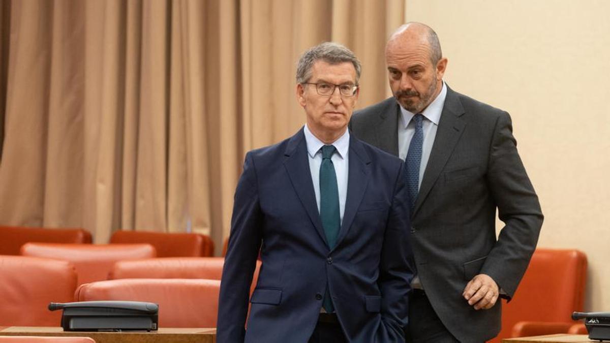 El líder del PP, Alberto Núñez Feijóo (i) y el presidente del Senado, Pedro Rollán (d), salen de la reunión de los grupos parlamentarios.