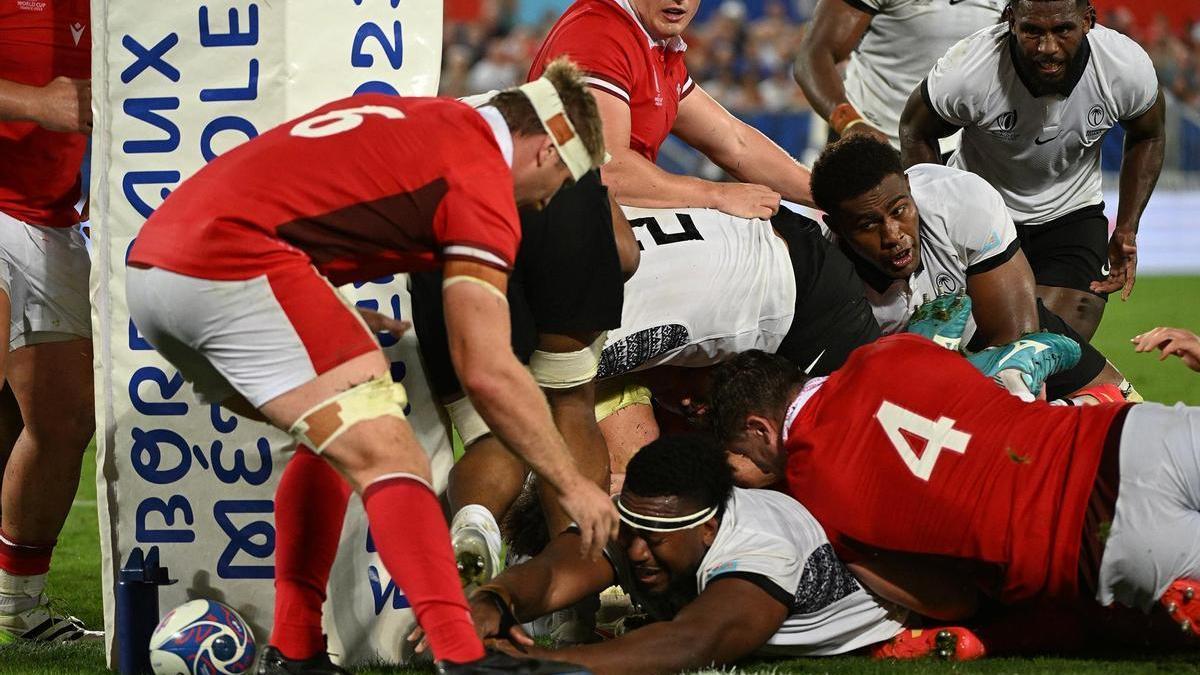 Un jugador de Fiyi trata de ensayar en el partido ante Gales