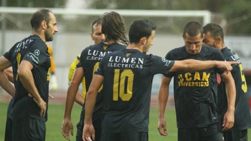 Varios jugadores del UCAM Murcia hablan con el árbitro durante una de las acciones del choque del Grupo IV