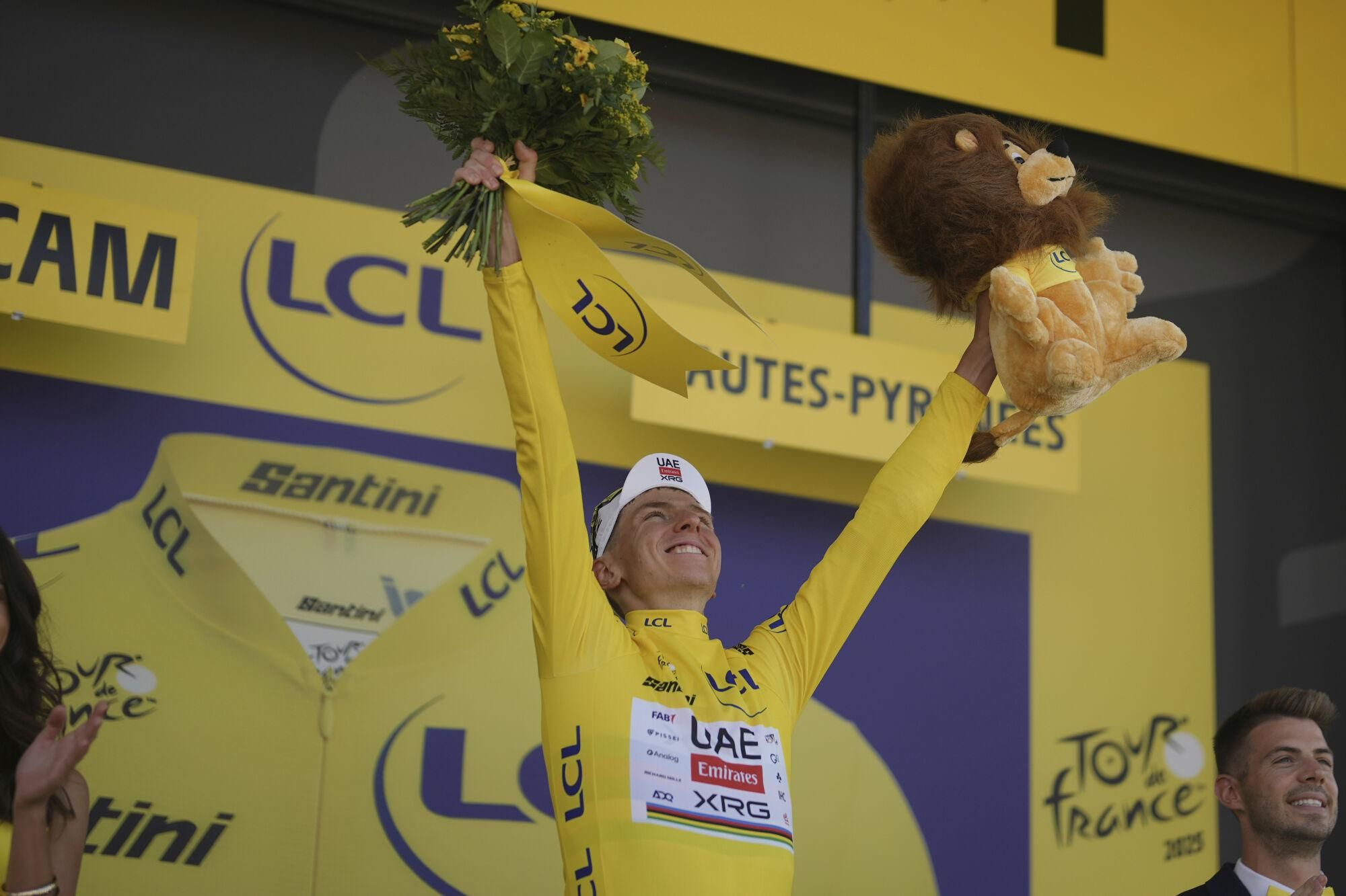 Slovenia's Tadej Pogacar celebrates taking the overall leader's yellow jersey after the twelfth stage of the Tour de France cycling race over 180.6 kilometers (112.2 miles) with start in Auch and finish in Hautacam, France, Thursday, July 17, 2025. (AP Photo/Thibault Camus)