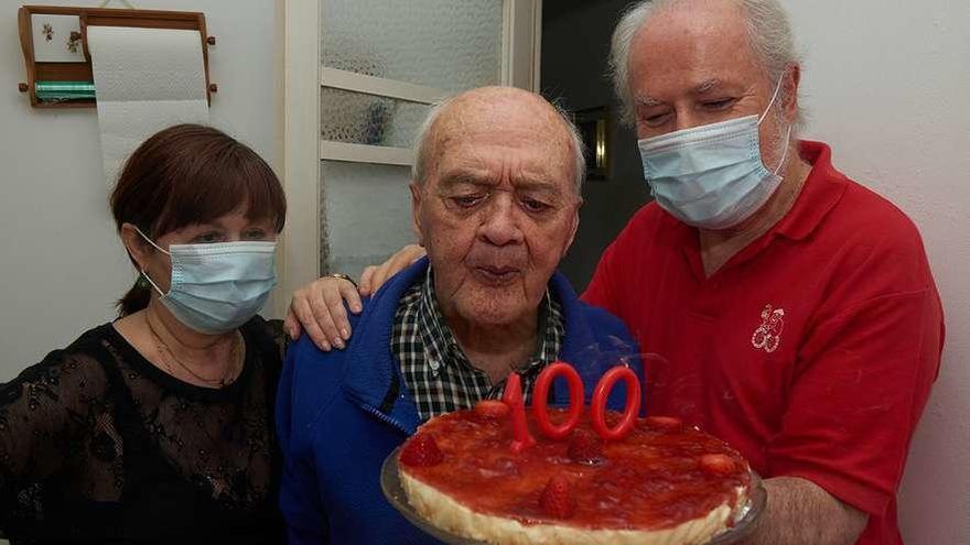 Manuel Sobrino Añón sopla las velas por su cumpleaños, con su hija y su yerno.