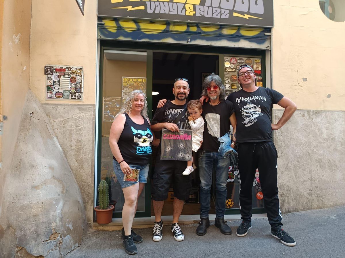 Los integrantes de Guadaña posan con algunos de sus fans frente a la tienda Purple Haze, en Palma