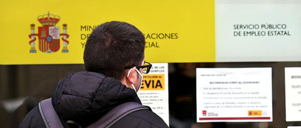 Un hombre mira el cristal de una oficina de empleo.