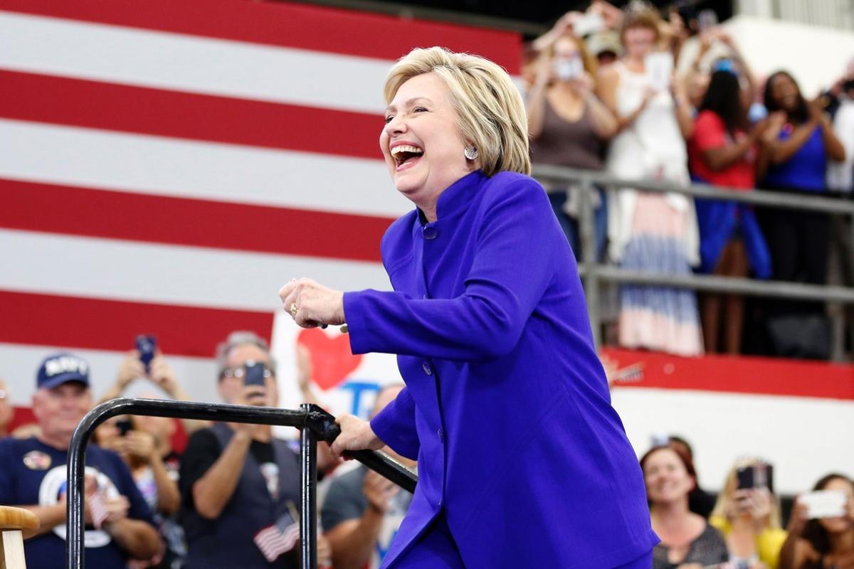 TOPSHOT - Democratic presidential candidate Hillary Clinton arrives on stage for a rally at Long Beach City College on the final day of California campaigning, June 6, 2016 in Long Beach, California.