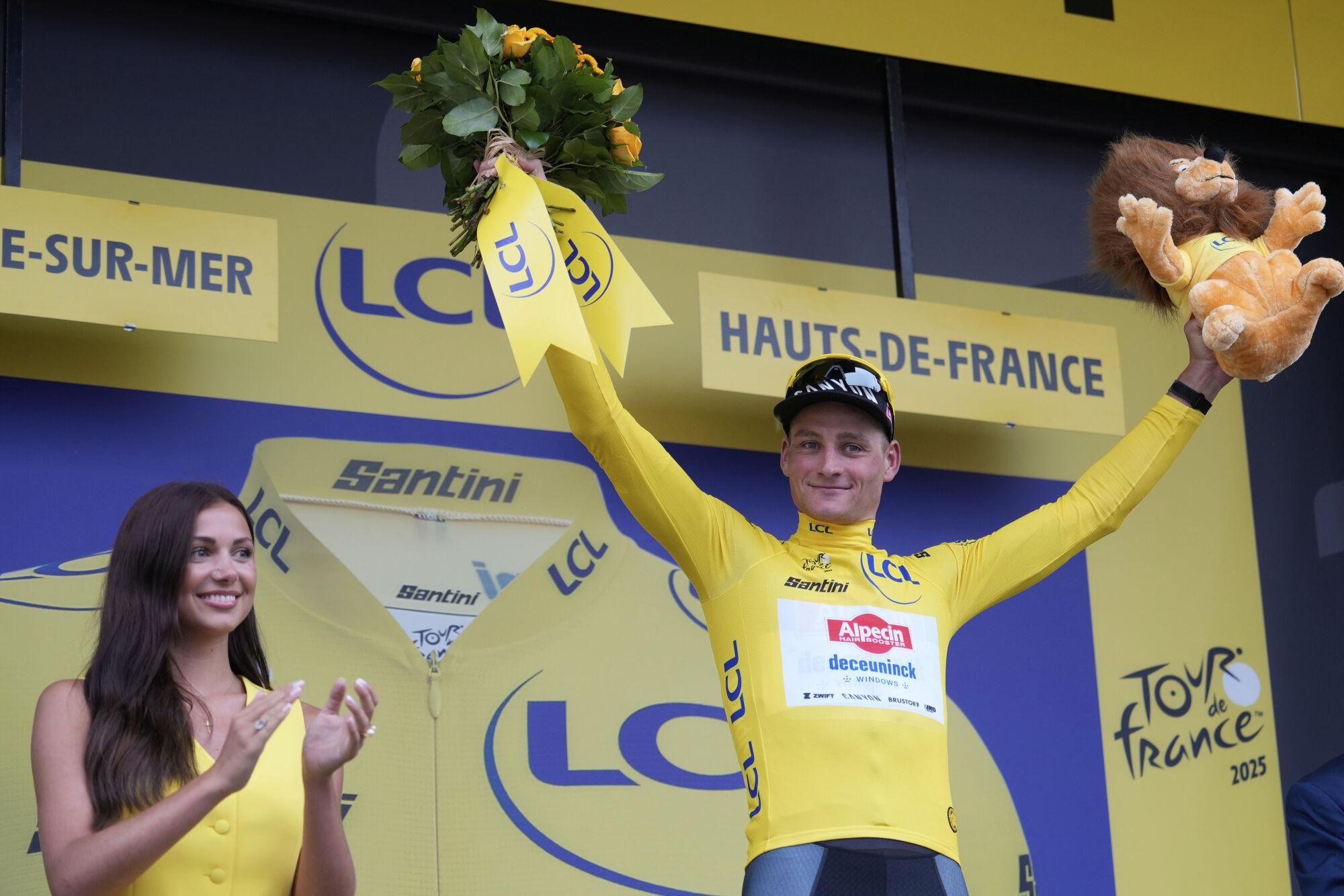 Netherlands' Mathieu van der Poel wearing the overall leader's yellow jersey celebrates on the podium after winning the second stage of the Tour de France cycling race over 209.1 kilometers (129.9 miles) with start in Lauwin-Planque and finish in Boulogne-sur-Mer, France, Sunday, July 6, 2025. (AP Photo/Mosa'ab Elshamy). EDITORIAL USE ONLY/ONLY ITALY AND SPAIN