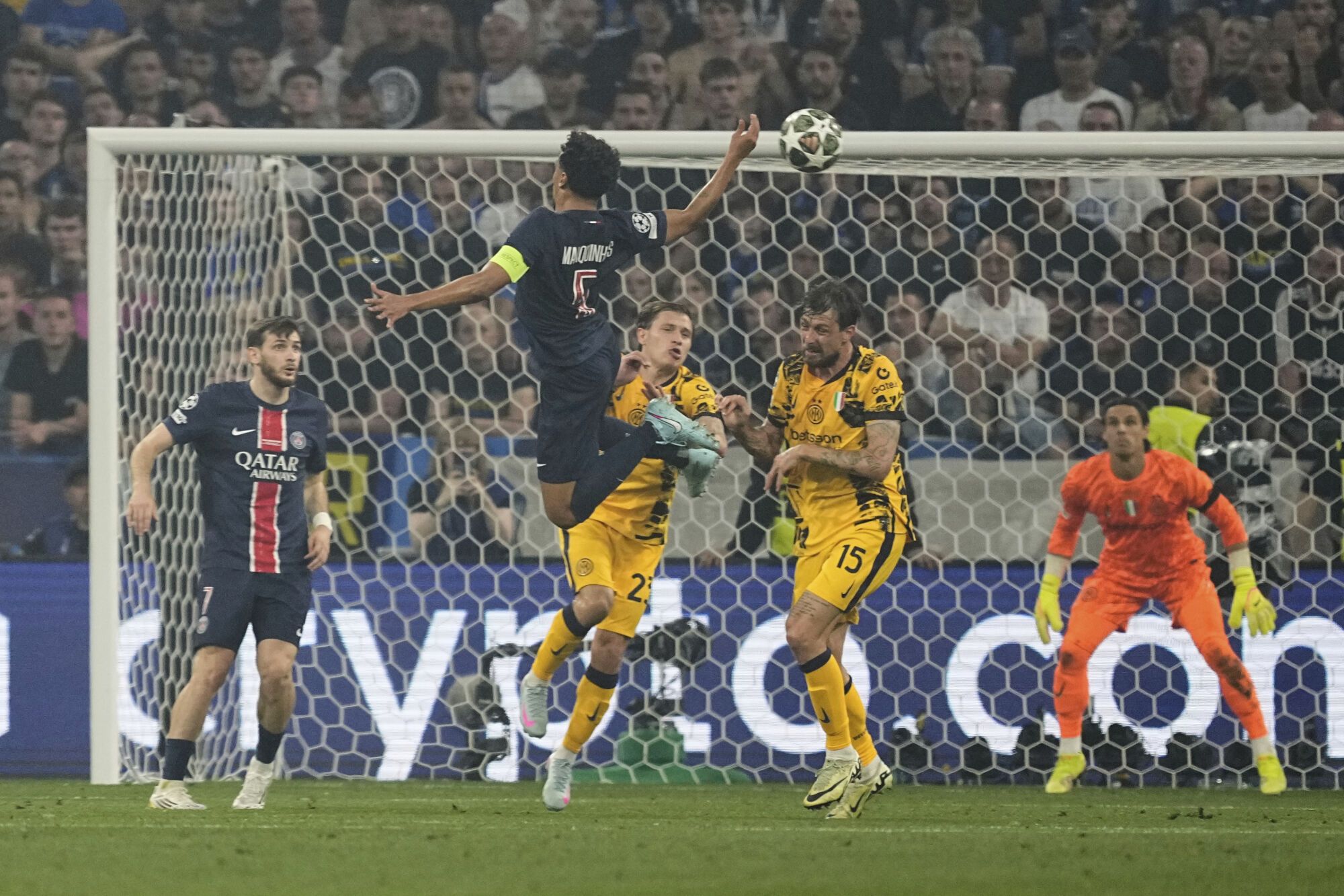 PSG's Marquinhos, top left, is challenged by Inter Milan's Nicolo Barella, center, and Inter Milan's Francesco Acerbi during the Champions League final soccer match between Paris Saint-Germain and Inter Milan at the Allianz Arena in Munich, Germany, Saturday, May 31, 2025. (AP Photo/Martin Meissner)