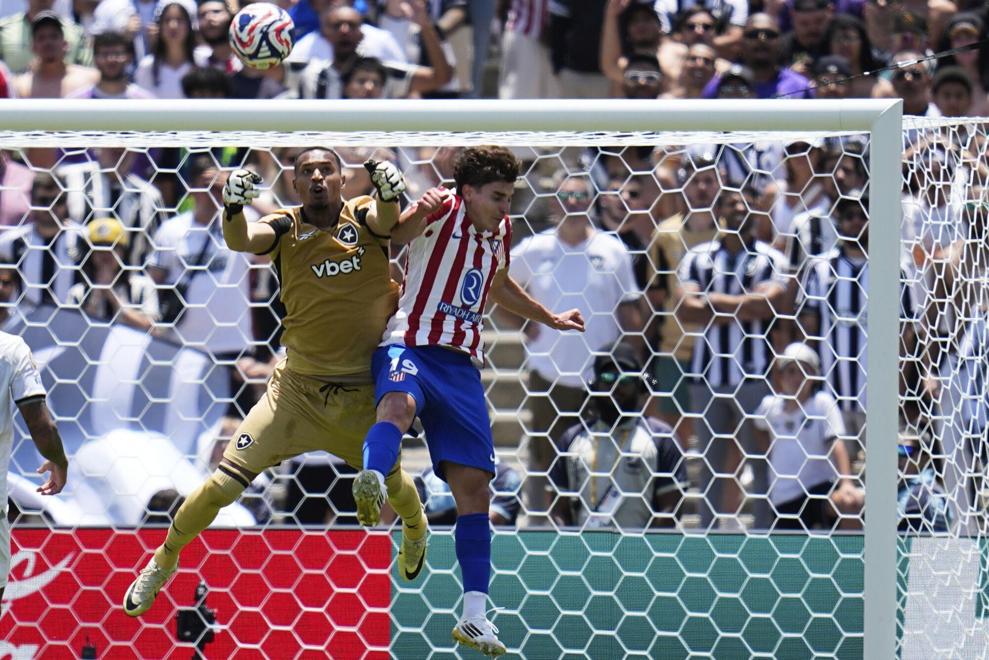Atletico Madrid's Julian Alvarez (19) and Botafogo's John battle for the ball during the Club World Cup Group B soccer match between Atletico Madrid and Botafogo in Pasadena, Calif., Monday, June 23, 2025. (AP Photo/Gregory Bull)