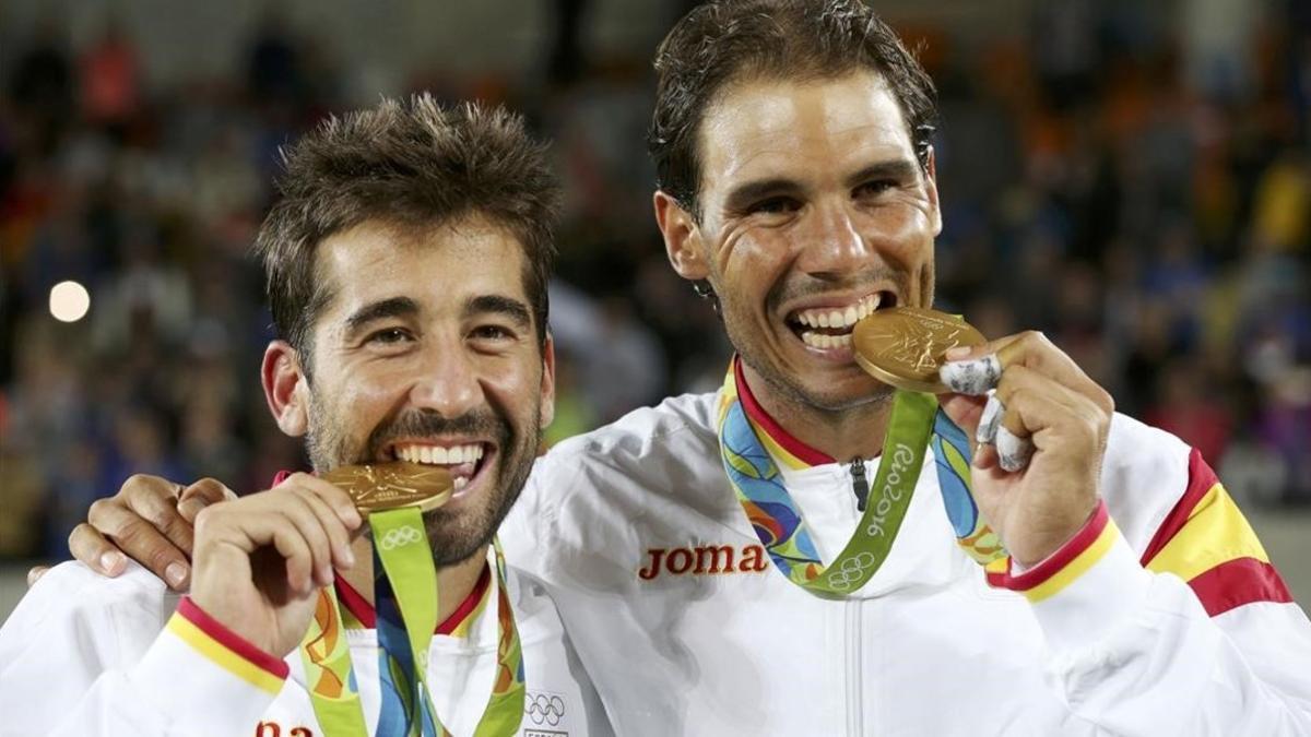 Marc López y Rafael Nadal muerden las medallas de oro.