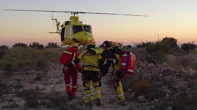 Los bomberos trasladando al herido hasta el helicóptero