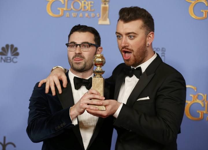 Smith and Napes pose with the award for Best Original Song - Motion Picture from the film " for "Writing's on the Wall" from the film "Spectre" backstage at the 73rd Golden Globe Awards in Beverly Hills