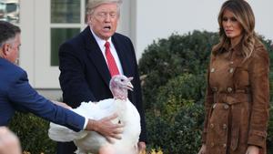 U.S. President Donald Trump pardons one of the 72nd National Thanksgiving Turkeys as Wellie Jackson, who raised the turkey, holds onto it and first lady Melania Trump looks on during ceremonies in the Rose Garden at the White House in Washington, U.S., November 26, 2019. REUTERS/Loren Elliott