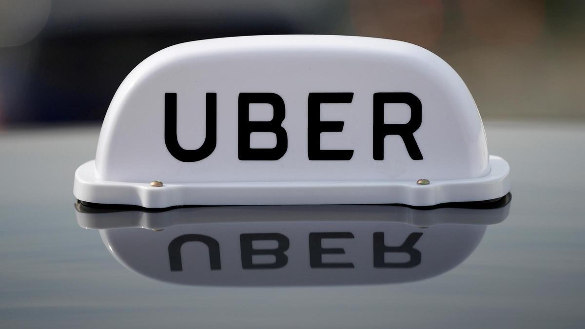 FILE PHOTO: The Logo of taxi company Uber is seen on the roof of a private hire taxi in Liverpool