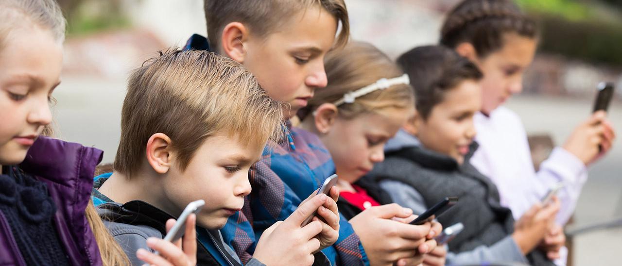Un grupo de niños con teléfonos móviles