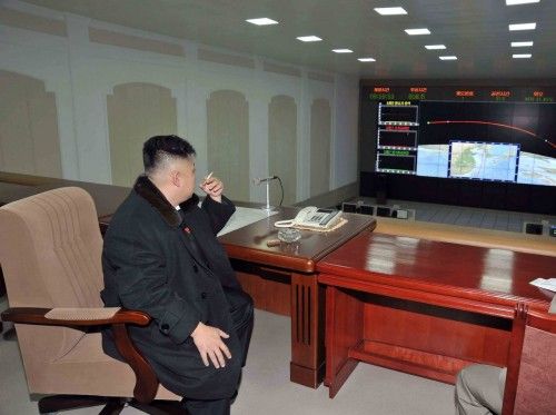 North Korean leader Kim Jong-Un smokes a cigarette at the General Satellite Control and Command Center in this picture released by the North's KCNA news agency in Pyongyang