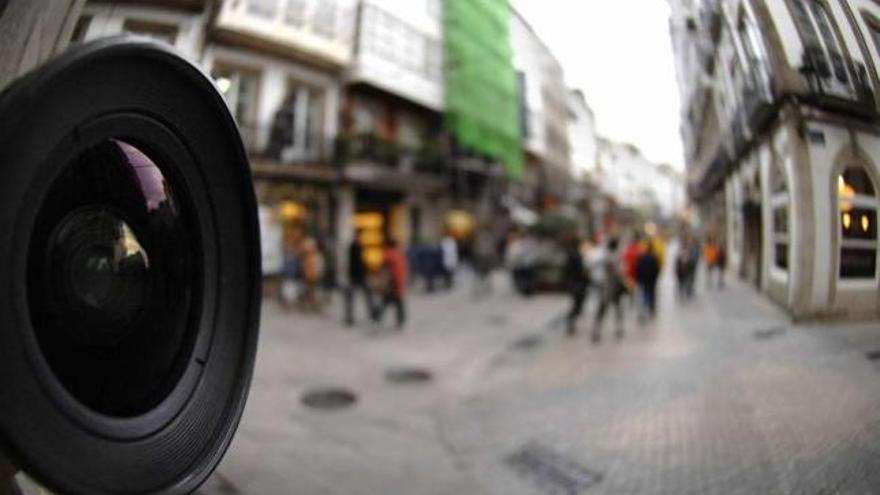 Una cámara vigila una céntrica calle coruñesa. / fran martínez