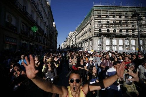 Demonstrators playing percussion instruments march in the Puerta del Sol on the second anniversary of the 15M movement in central Madrid