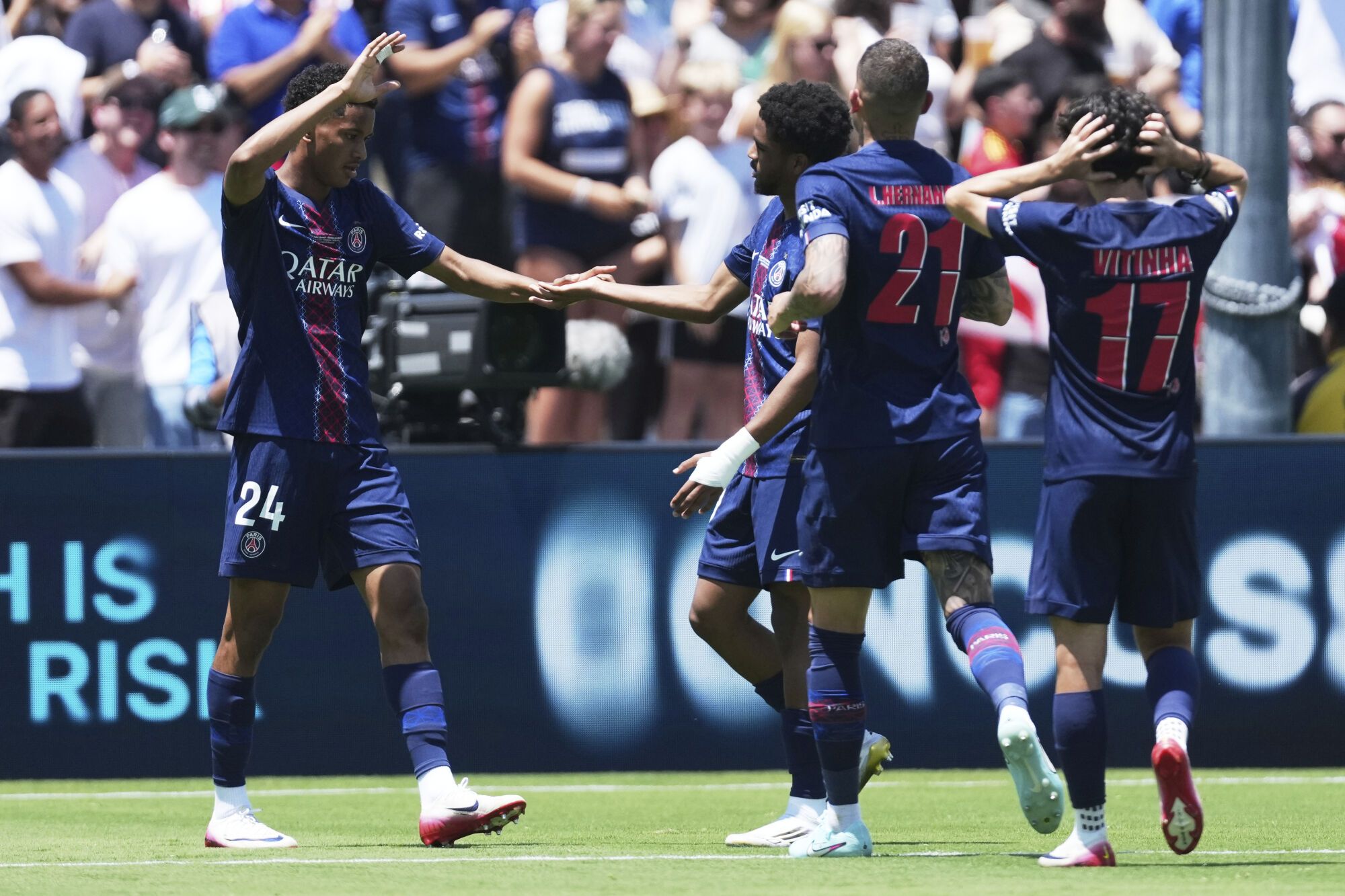 Paris Saint-Germain's Senny Mayulu (24) celebrates with teammates after scoring his side's third goal during the Club World Cup group B soccer match between PSG and Atletico Madrid in Pasadena, Calif., Sunday, June 15, 2025. (AP Photo/Jae Hong)