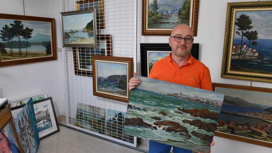 Camilo Chas, gerente de Artby’s, con los cuadros de José Francisco Pérez Martínez.