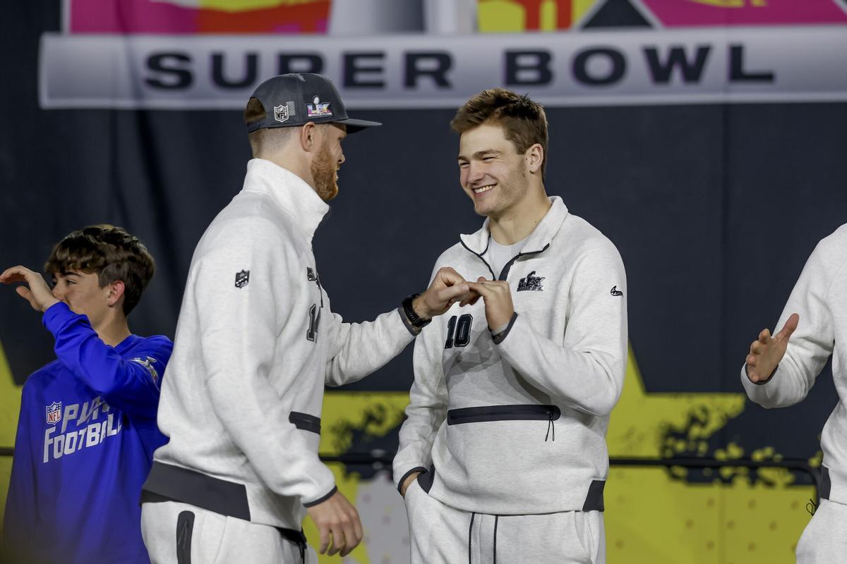 Drake Maye (sin gorra), quarterback de los New England Patriots, saluda a Sam Darnold, quarterback de los Seattle Seahawks.