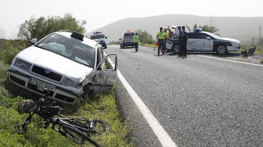 La bici y el taxi, uno de los dos coches implicados en el choque.